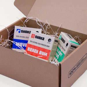 Box of Shaka soap bars with various scents on a white background